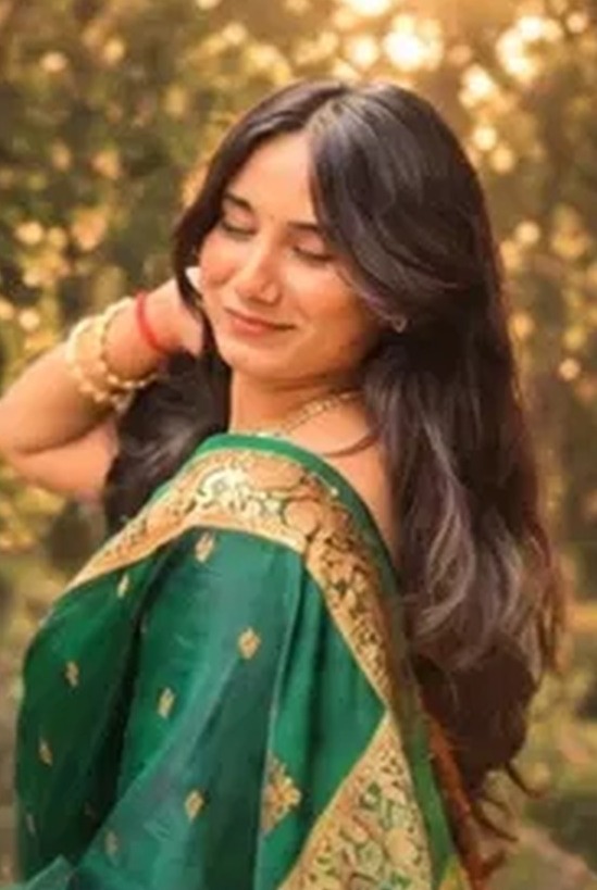 Woman in a green Paithani saree in golden light
