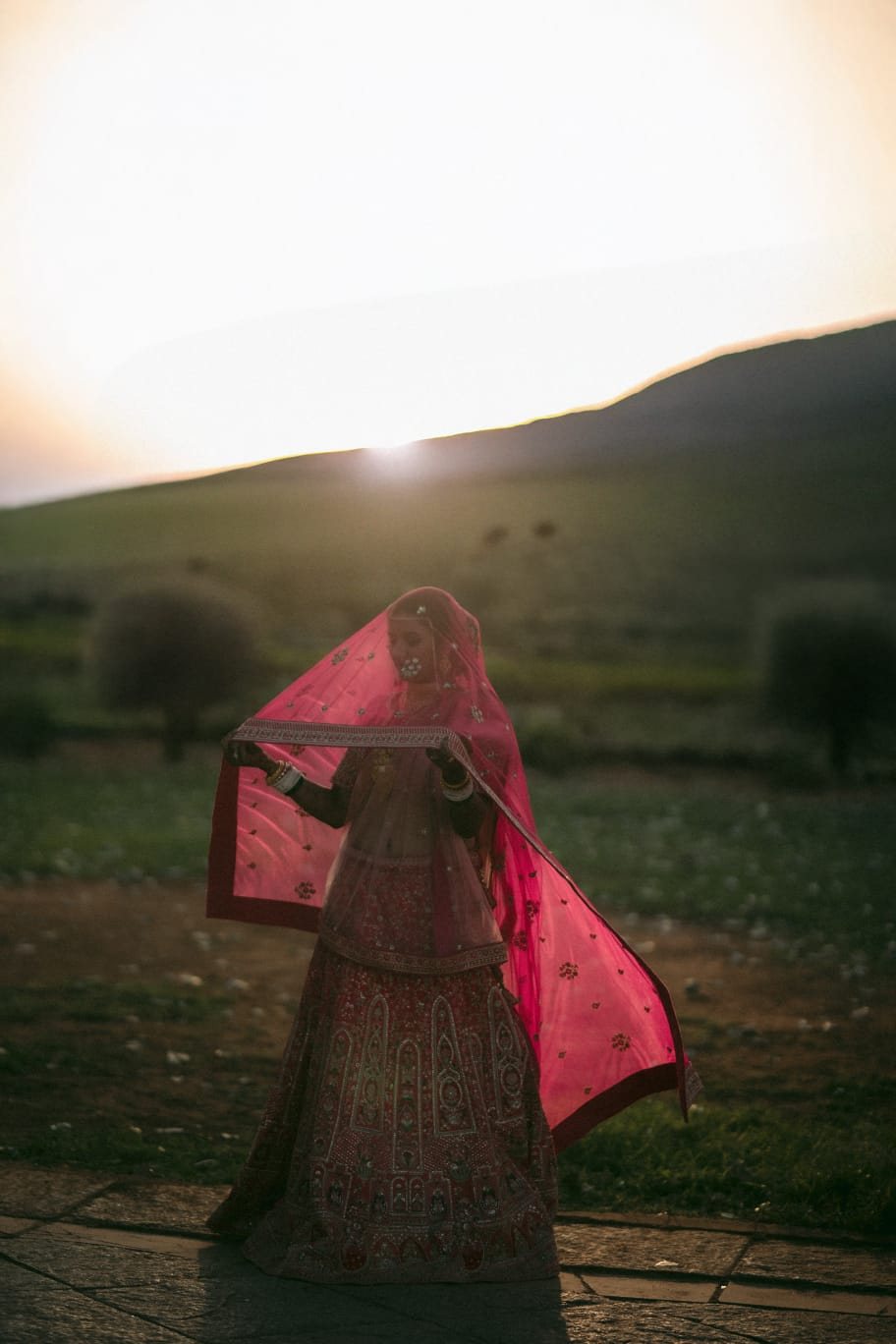 Bride in a pink veil at sunset